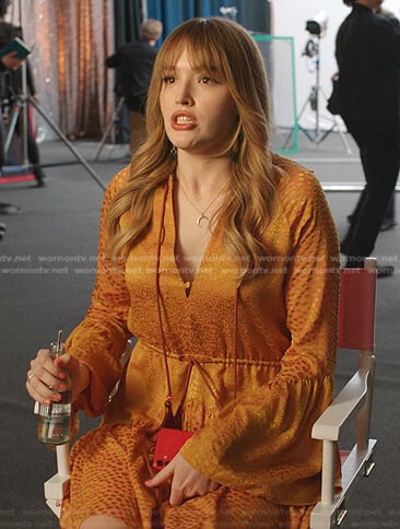 Kirby’s orange patterned tie neck dress on Dynasty