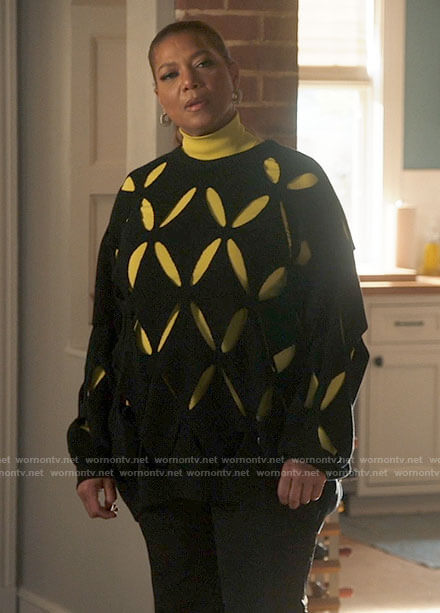 Robyn’s black sweater with cutouts and spiral hoop earrings on The Equalizer