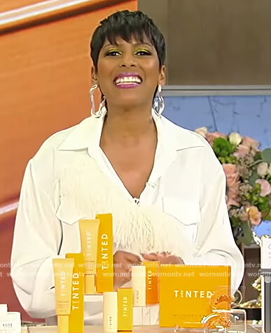 Tamron’s white feather trim dress on Tamron Hall Show