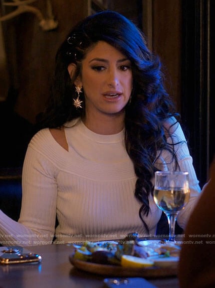 Beth Ann’s white cutout shoulder top and star earrings on I Love That For You