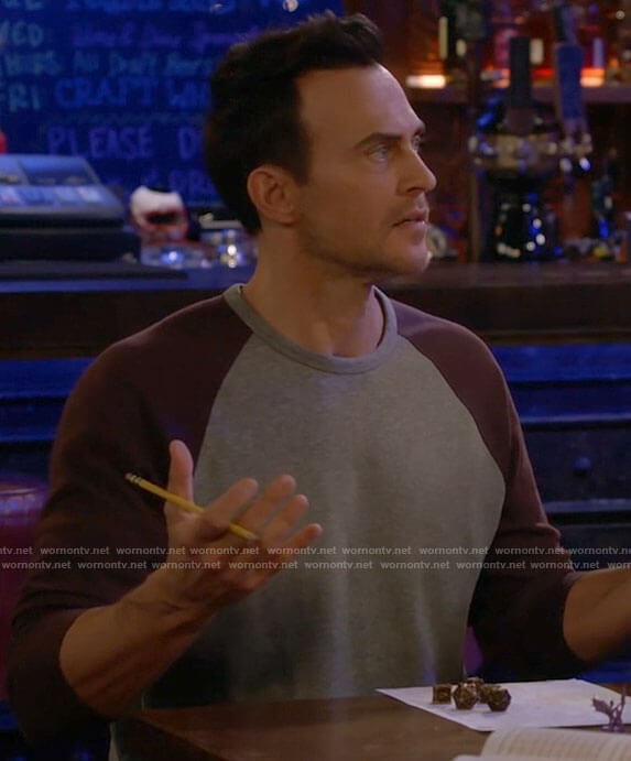 Max’s grey shirt with purple sleeves on Call Me Kat