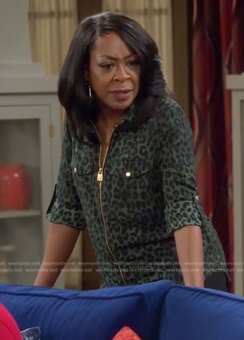 Tina’s green leopard print zip up top on The Neighborhood