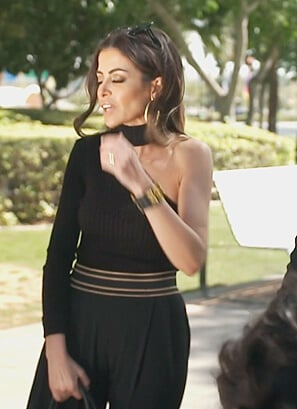 Nina’s black one shoulder sweater on The Real Housewives of Dubai