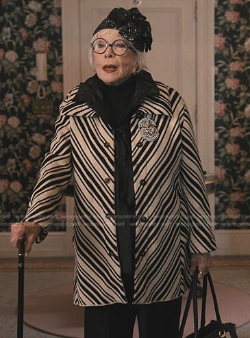 Leonora’s white diagonally striped coat on Only Murders in the Building