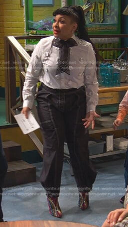 Raven’s black belted pants with white stitching on Ravens Home