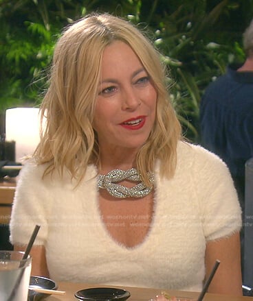 Sutton’s white short sleeve sweater with crystal knot on The Real Housewives of Beverly Hills