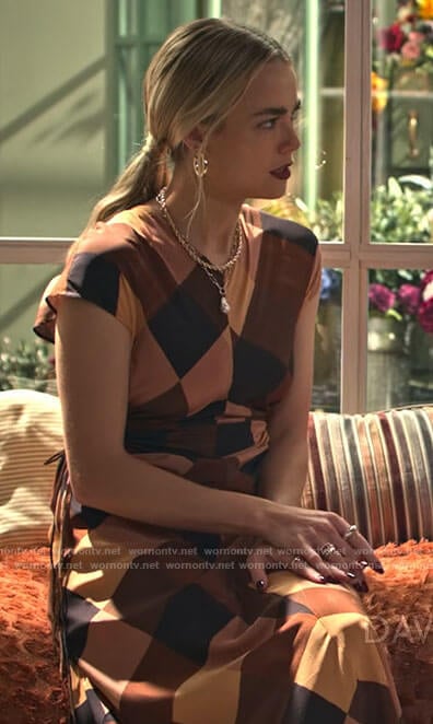 Maggie’s brown block print dress with side cutouts on Maggie