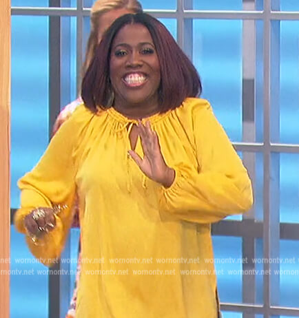 Sheryl’s yellow tie neck blouse on The Talk