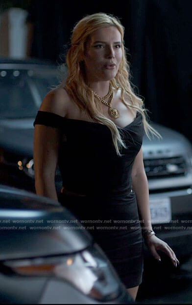 Marci’s black off-shoulder top and large pendant necklace on American Horror Stories