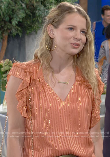 Summer’s orange ruffled blouse with metallic stripes on The Young and the Restless