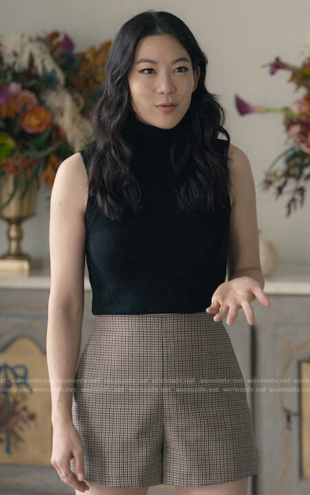 Ingrid’s houndstooth shorts and black sleeveless turtleneck on Partner Track