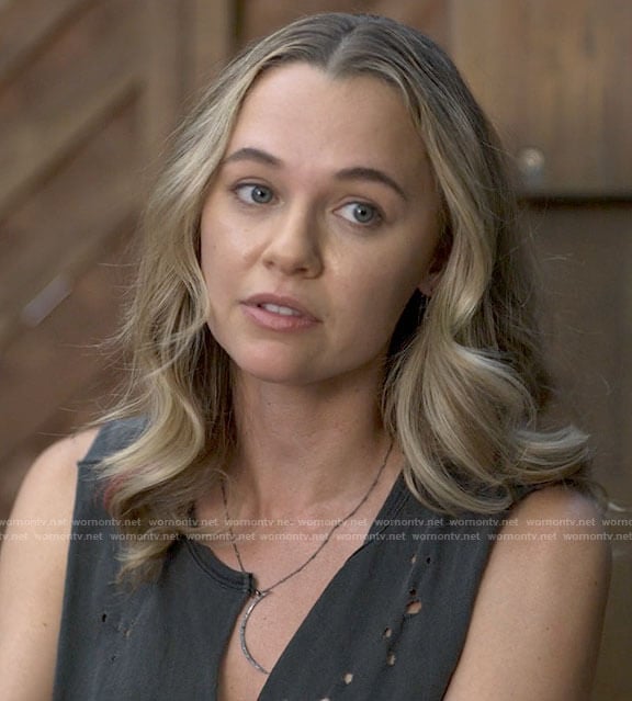 Sam’s black distressed tank top and white boots on American Horror Stories