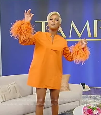 Tamron’s orange feather trim dress on Tamron Hall Show