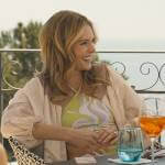 Daphne’s green swirl print bikini and palm print cover-up on The White Lotus