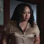 Karen’s champagne short sleeve satin shrit on 9-1-1