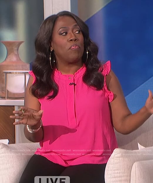 Sheryl’s pink ruffle neck top on The Talk