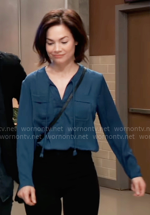 Elizabeth’s teal blue tie neck top with pockets on General Hospital