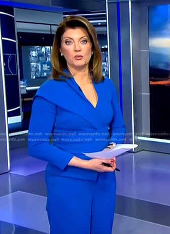 Norah’s blue asymmetric peplum top on CBS Evening News