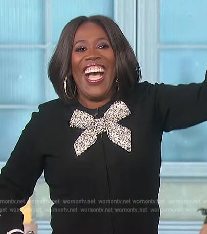 Sheryl’s black bow embellished cardigan on The Talk