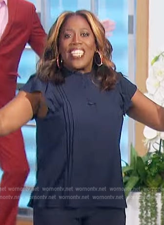 Sheryl’s navy pleated ruffle top on The Talk