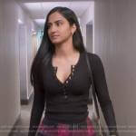 Bela’s black henley top and pink plaid skirt on The Sex Lives of College Girls