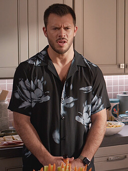 Connor’s black floral print shirt on Home Economics
