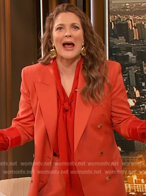 Drew’s orange blazer and tie neck blouse on The Drew Barrymore Show