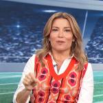 kit’s orange print vest and jeans on Access Hollywood