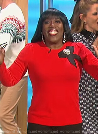 Sheryl’s red bow brooch sweater on The Talk