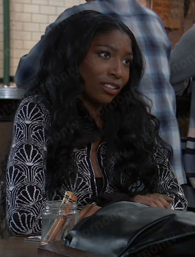 Trina’s black and white patterned zip up cardigan with fur trim on General Hospital