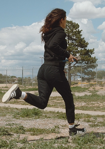 Jess’s black stripe sneakers on National Treasure: Edge of History