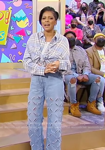 Tamron’s blue plaid shirt and eyelet jeans on Tamron Hall Show