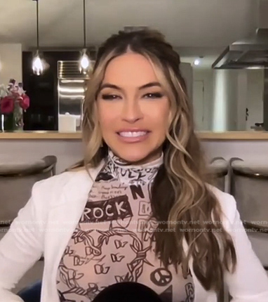 Chrishell Stause’s white printed turtleneck top on E! News