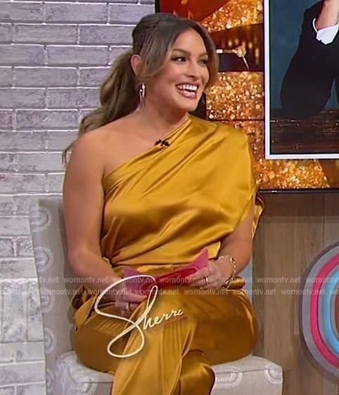 Emily Orozco’s gold satin one shoulder top and pants on Sherri