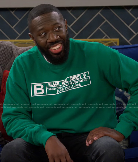 Malcolm’s green Black Wall Street sweatshirt on The Neighborhood