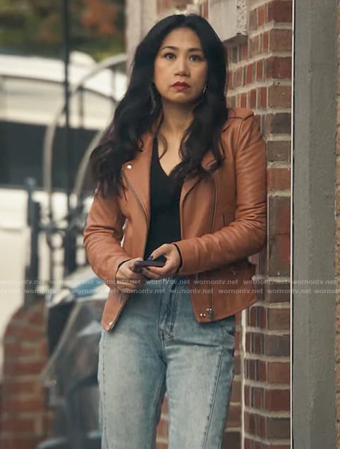 Mel’s orange leather moto jacket and front split jeans on The Equalizer