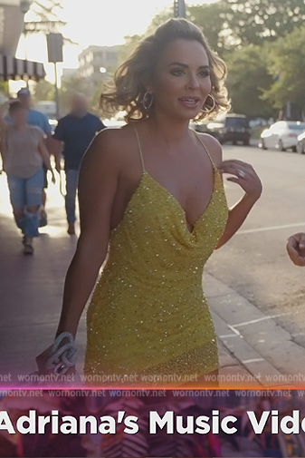 Nicole’s yellow embellished cowl neck mini dress on The Real Housewives of Miami