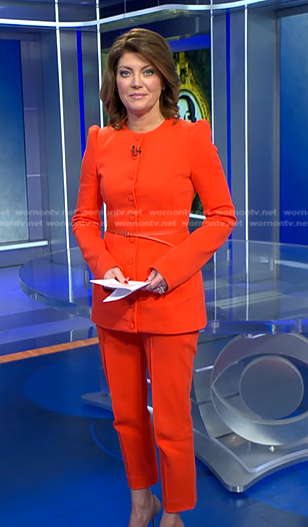 Norah’s orange belted jacket and cropped pants on CBS Evening News