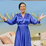 Tamron’s blue satin v-neck dress on Tamron Hall Show