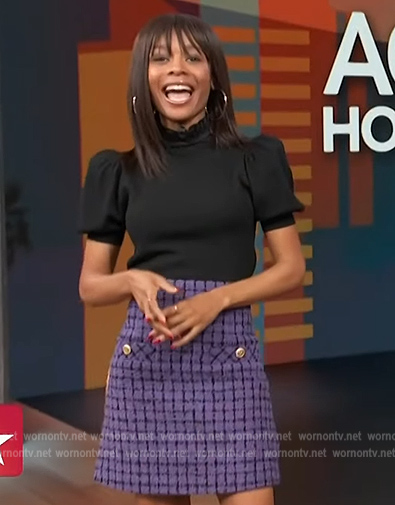 Zuri’s purple tweed skirt and black puff sleeve top on Access Hollywood