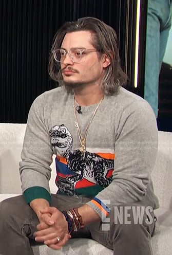 Andrew Lawrence’s grey dinosaur sweater on E! News