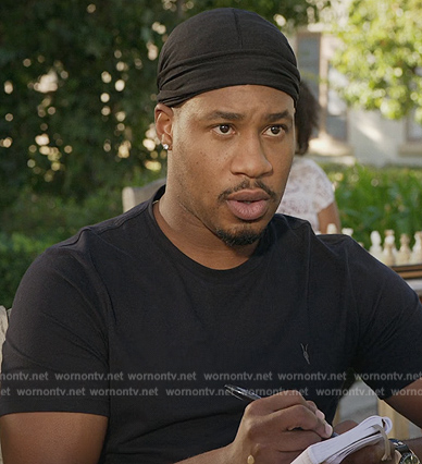 Anthony’s black logo tee on Grand Crew