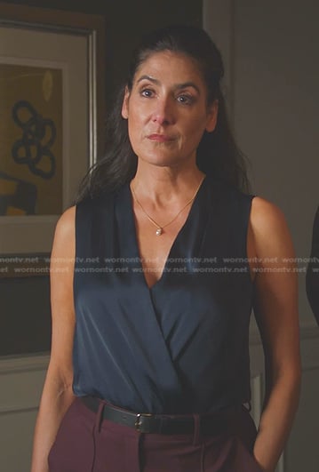 Carrie Walsh’s navy sleeveless surplice top on 9-1-1