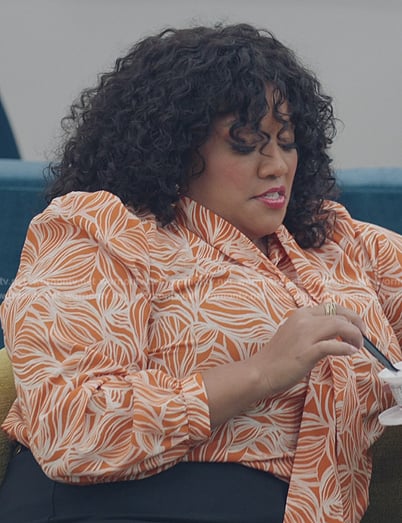 Dori’s orange floral print tie neck blouse on American Auto
