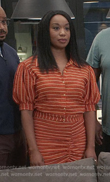 Kristen’s orange striped top and skirt on Grand Crew