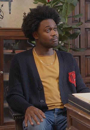 Noah’s black tiger patch cardigan on Grand Crew