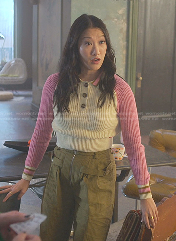 Sumi’s pink colorblock polo sweater and olive green pants on Good Trouble