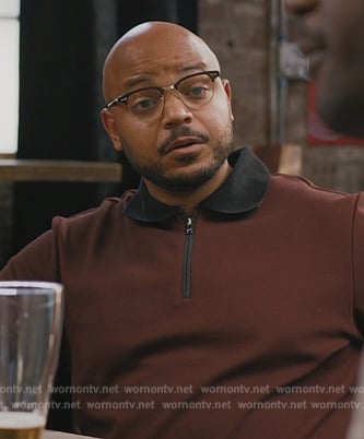 Wyatt’s contrast burgundy polo on Grand Crew