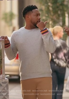 Anthony’s gray sweater with stripe cuffs on Grand Crew