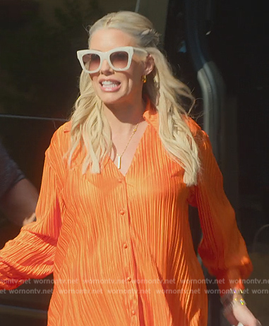 Heather’s orange pleated blouse and pants on Selling Sunset